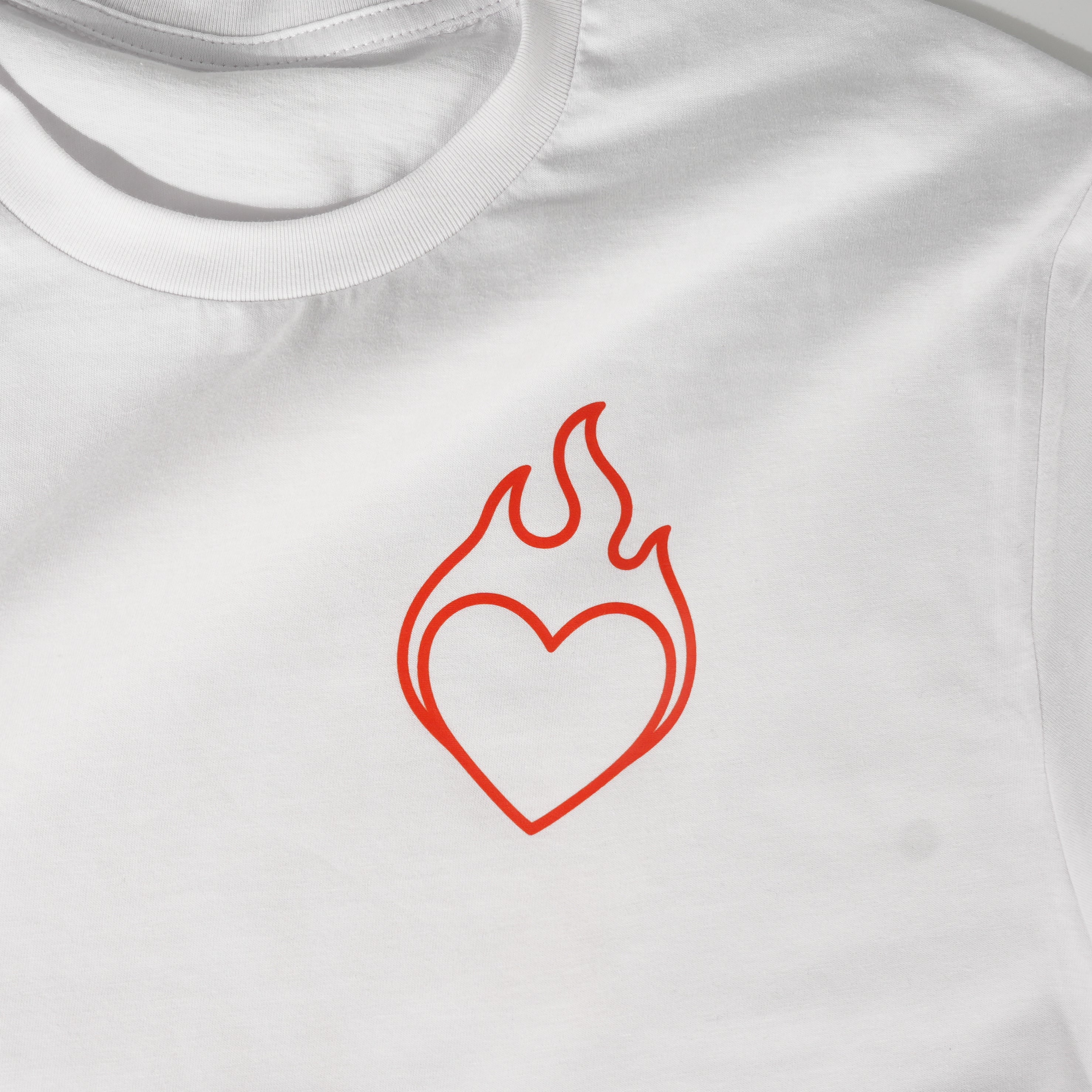 White t-shirt with a red heart and flame design on a white background