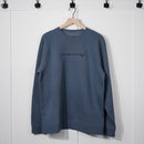 Blue sweatshirt with text on a hanger against a white background
